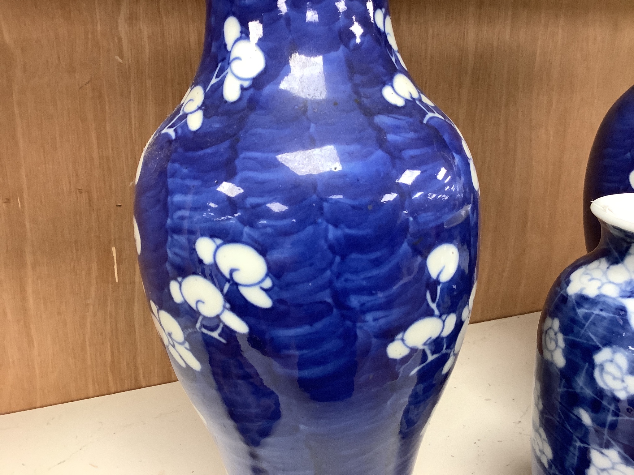 A pair of late 19th century Chinese prunus blossom baluster vases, 30cm, and a Japanese ovoid vase